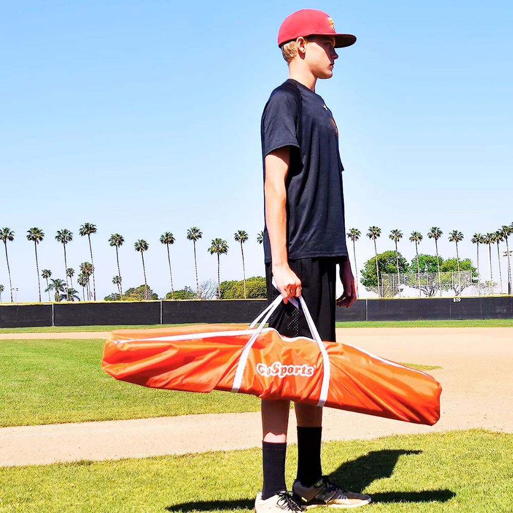 Image of baseball player cleaning pitching net
