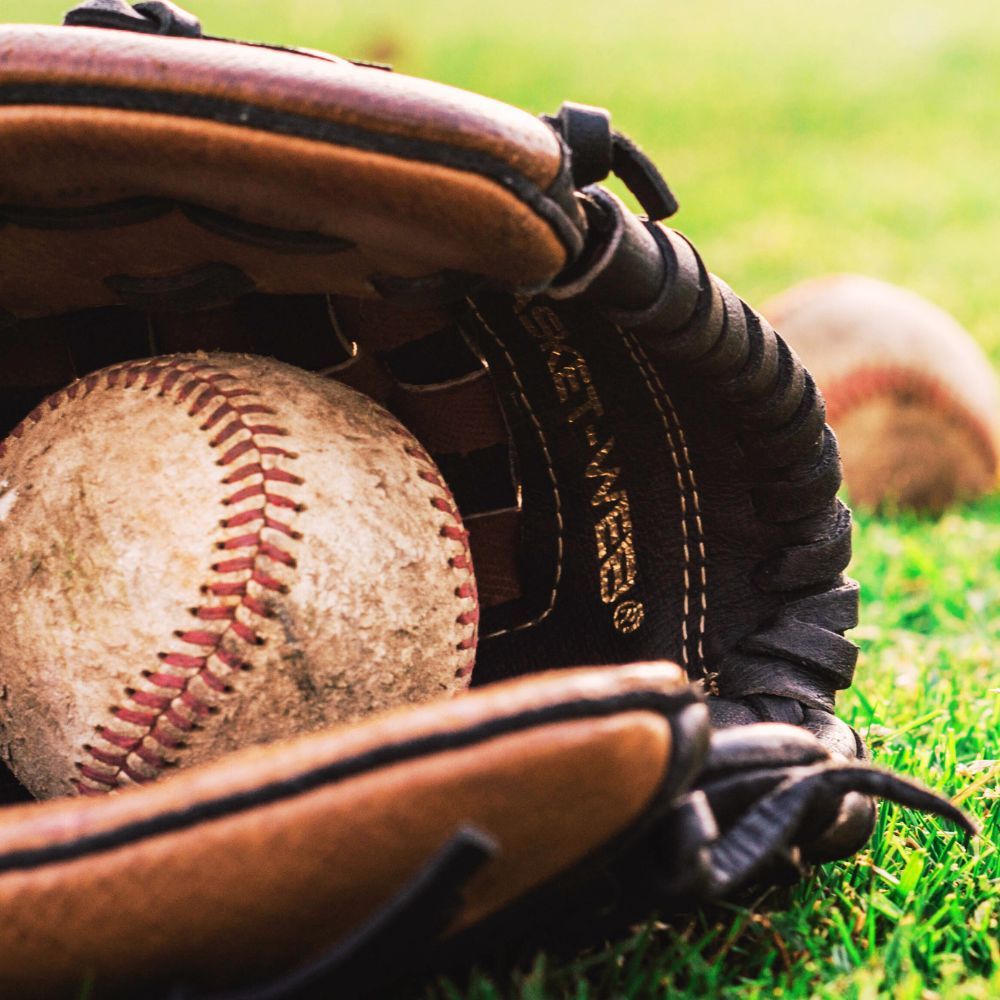 A picture of a person trying on a baseball glove